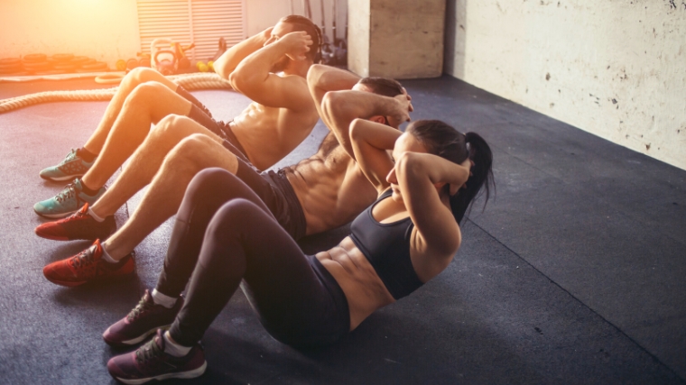 A group doing sit-ups together.