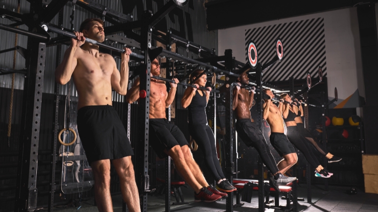 A group of people doing pull ups.