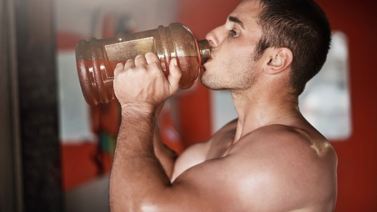 A person drinking before working out.