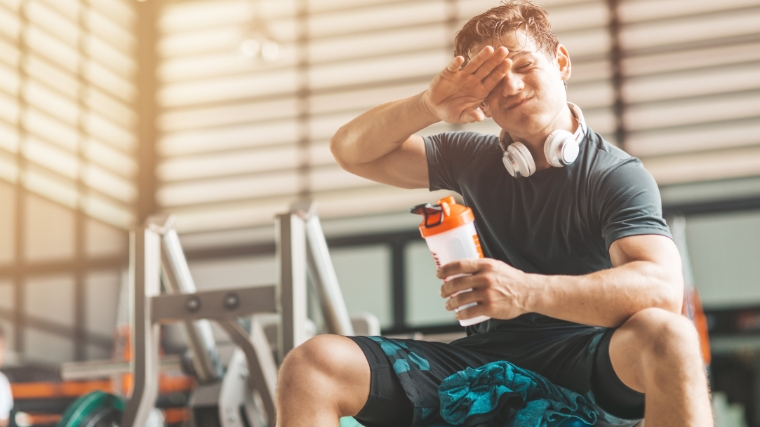 A person wiping his sweat after working out.