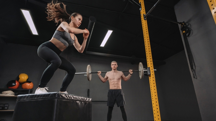 Two people working out at a Crossfit box.