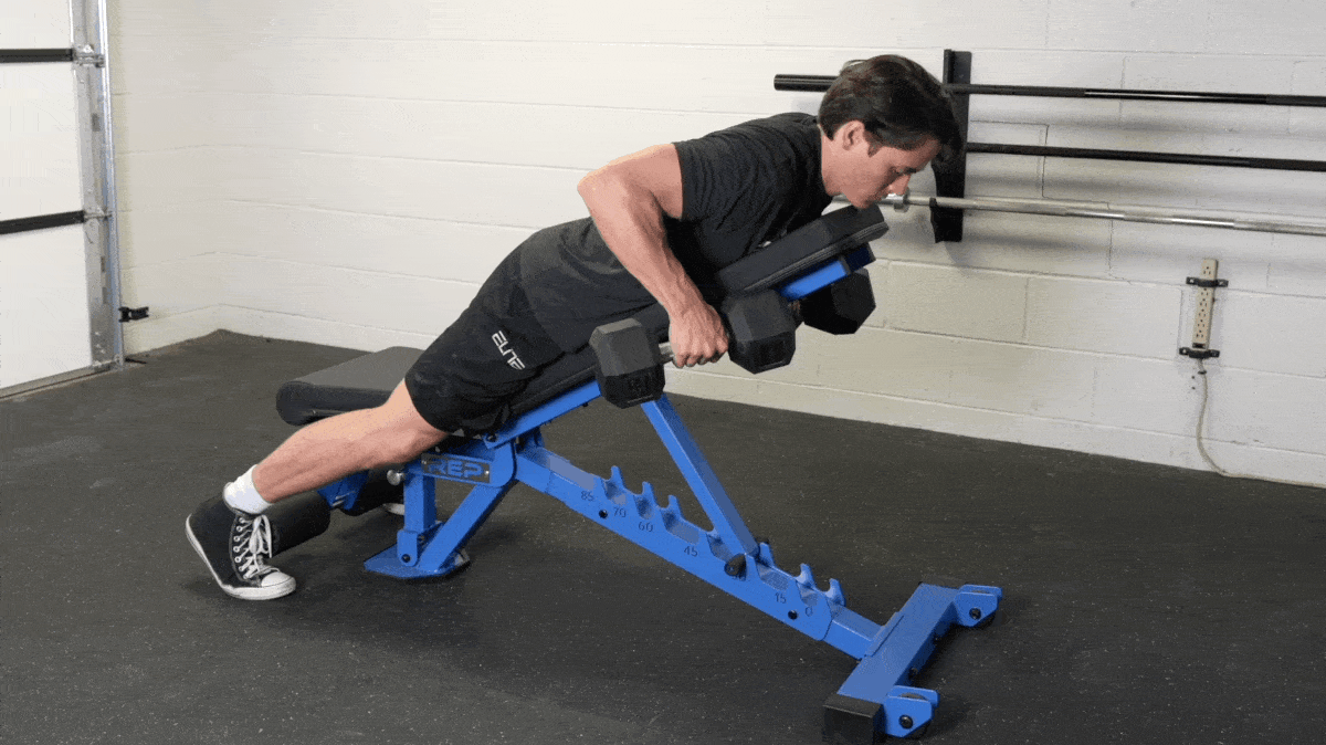 A person doing the chest supported row with dumbbells.