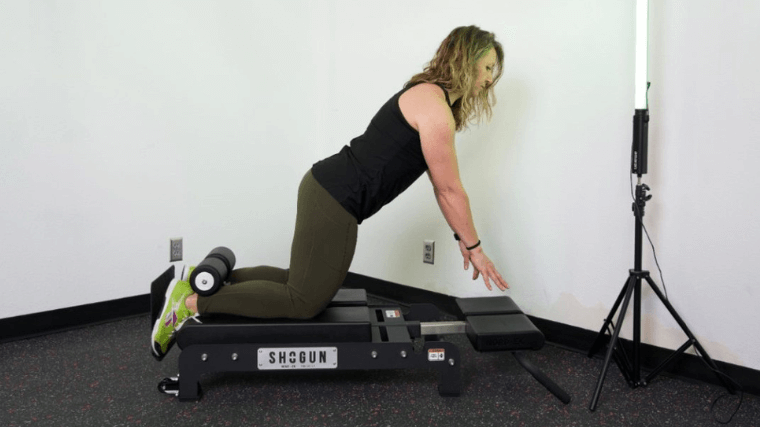 A BarBend tester performing Nordic curls on the Shogun NORD-EX.