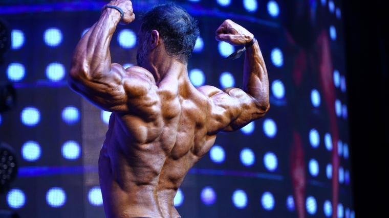 A bodybuilder posing at a competition.