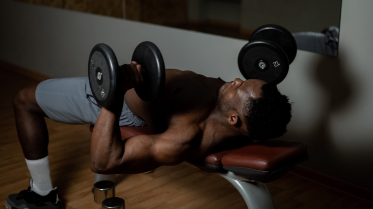 A person doing the dumbbell press.