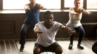 Three people doing air squats.