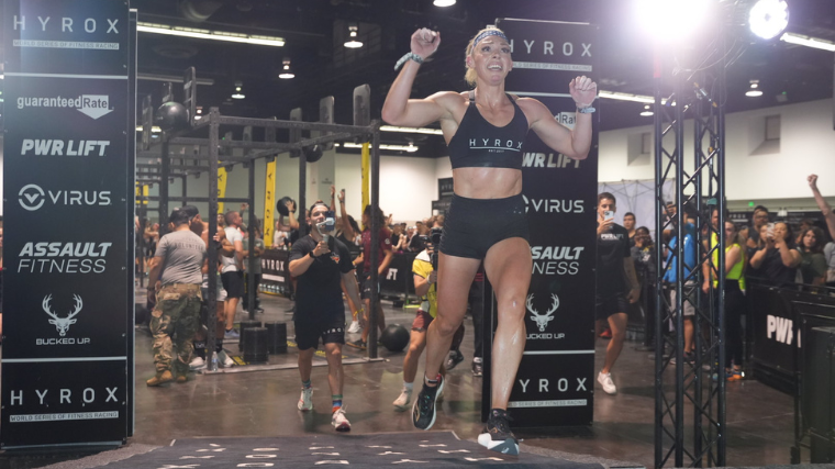 Megan Jacoby smiles as she crosses the finish line of her world record-breaking run at HYROX Anaheim.