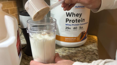 A BarBend tester sampling Nutricost whey protein concentrate.