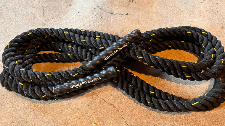 The Amazon Basics Battle Ropes on the ground of the BarBend gym.