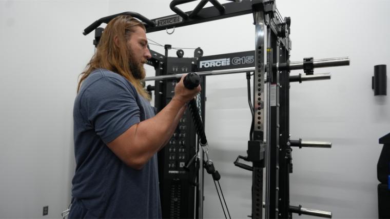 Our tester performing a triceps curl on the similar Force USA G15.