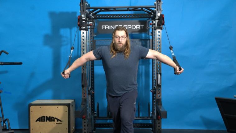A person performs chest flyes using the Fringe Sport Dane 2.0