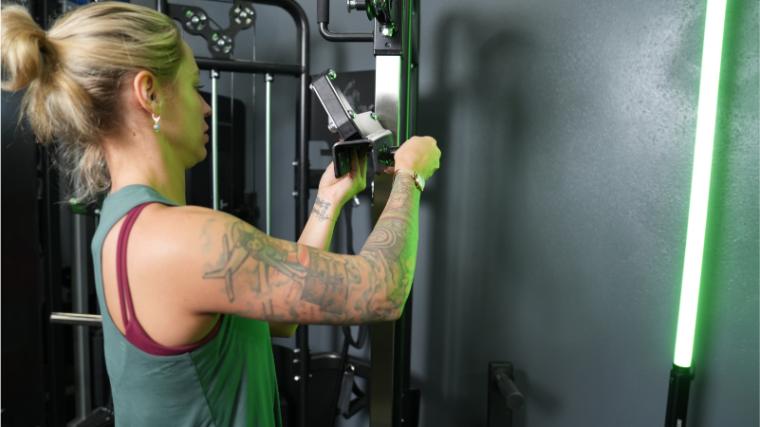 Our tester swapping out the J-hook on the Gronk Fitness Functional Trainer.