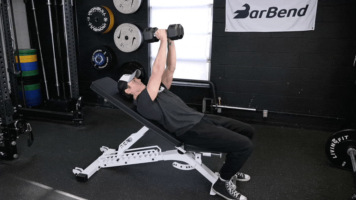 A person doing the incline hex press.