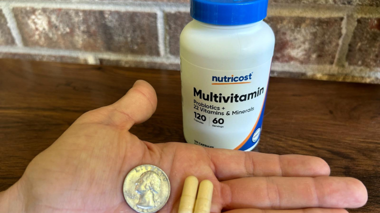 Comparing the size of a Nutricost Multivitamin to a quarter.