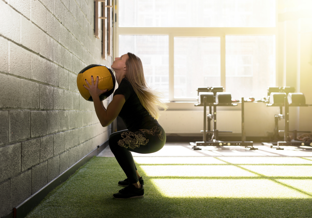 A person doing wall ball shots.