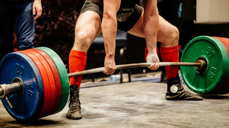 An athlete deadlifting at a competition.