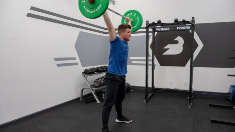 A person performing the muscle snatch.