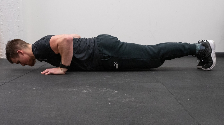 The second push-up position with the body close to the ground.