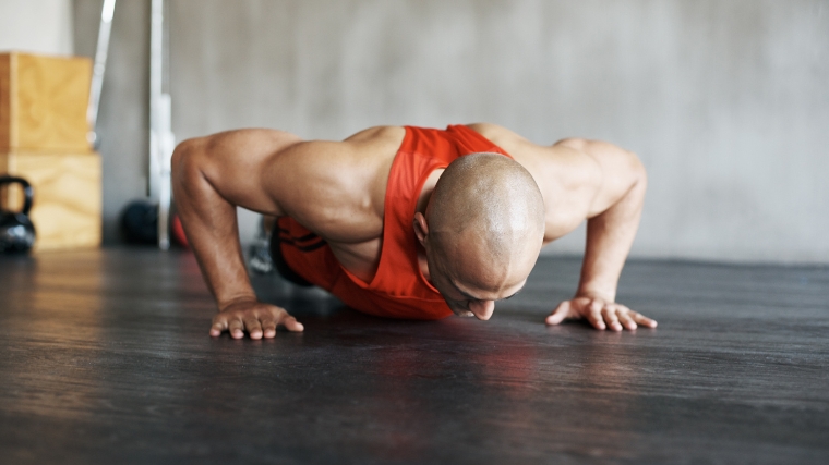 A muscular person doing push-ups.