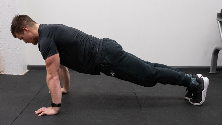 The starting push-up position, similar to the standard plank.