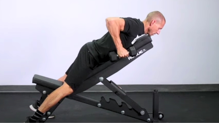 A person doing the chest supported row.