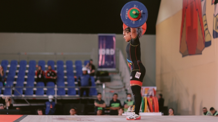 A weightlifter lifting a barbell overhead.