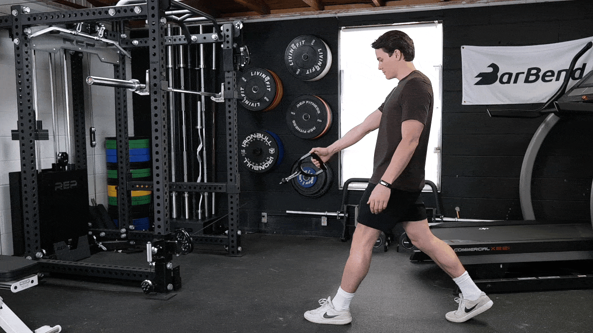 A person doing the low-cable split squat movement.
