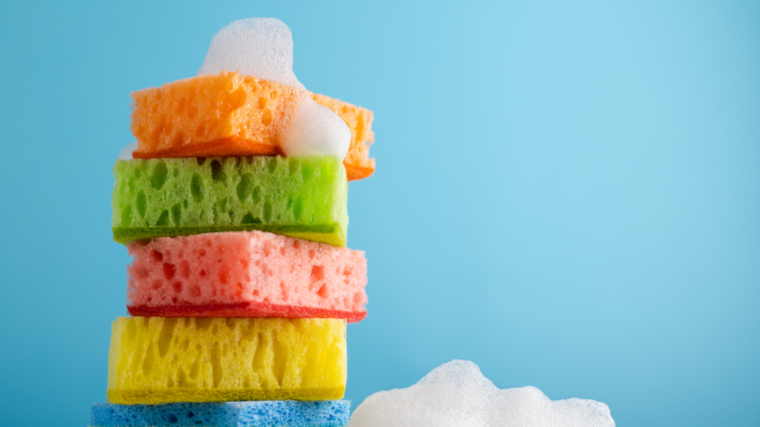 Soapy sponges on a blue background. 