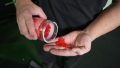 A person holds a handful of red Swoly Creatine Gummies.