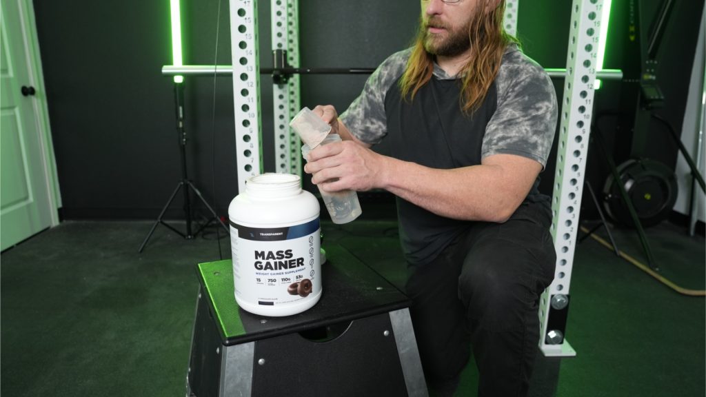 A BarBend tester mixing Transparent Labs Mass Gainer.