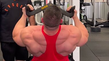 Bodybuilder Derek Lunsford performing lat pulldowns using a MAG grip attachement.