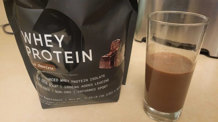 A bag of Sports Research Whey Protein Isolate with shake.