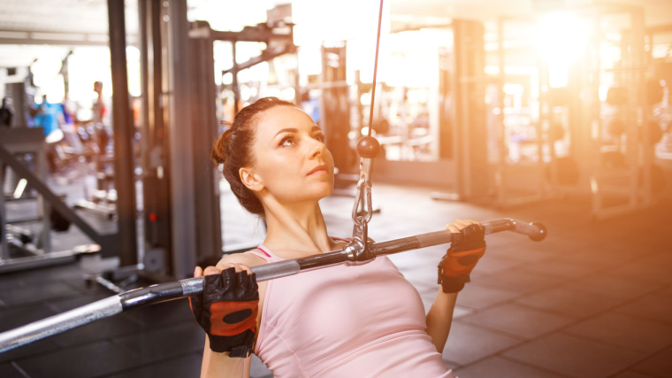 An athlete performs a reverse-grip lat pulldown.