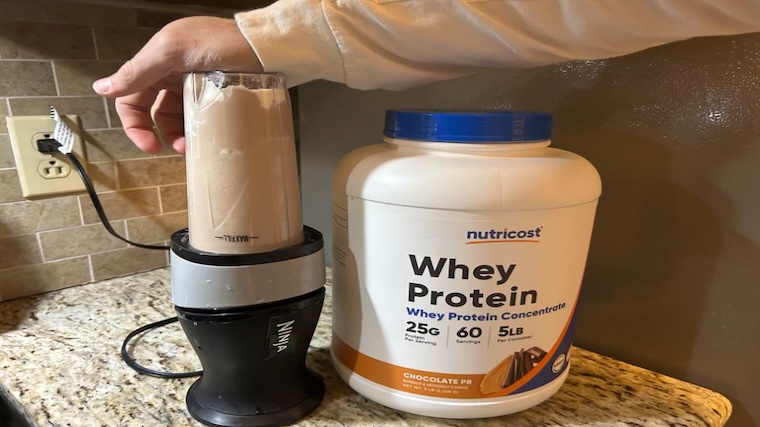 Our tester blending a shake of Nutricost Whey Protein Concentrate
