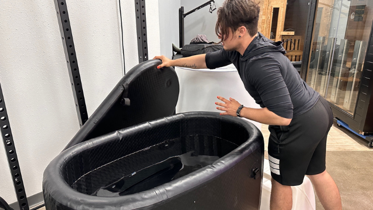 A person removing the cover for the Hydragun Supertub.