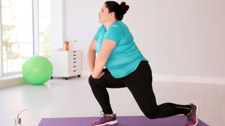 A person doing lunges on a mat.