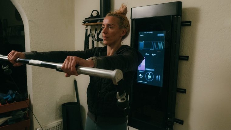 Former BarBend tester Rosie Borchert working out with a Tonal machine.