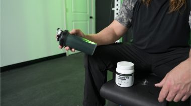 Our tester shaking the Transparent Labs prebiotic greens in a blender bottle