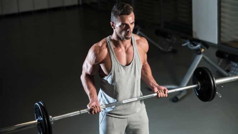 A bodybuilder doing drag curls.