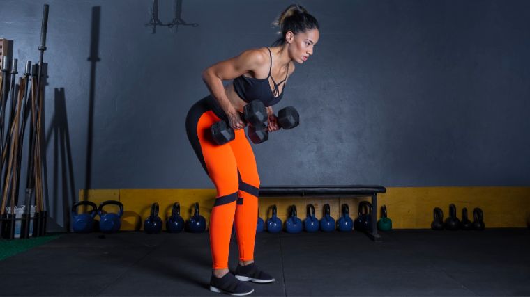 A person working out with dummbells.