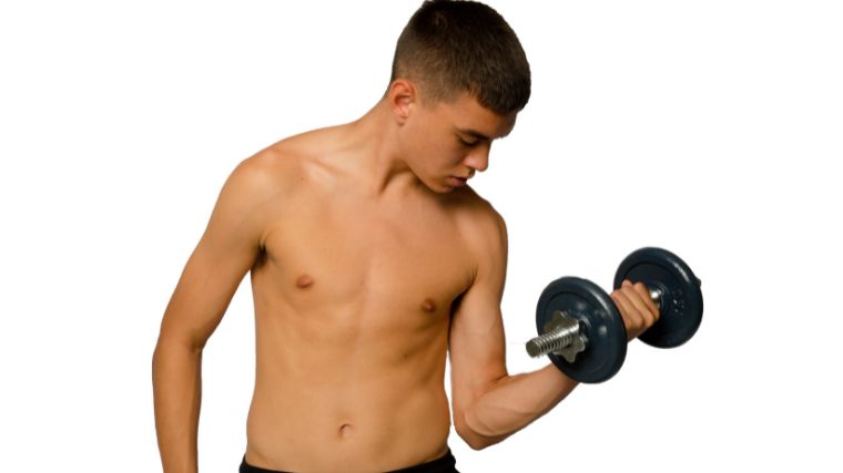 A young person concentrating on hi arm muscles.