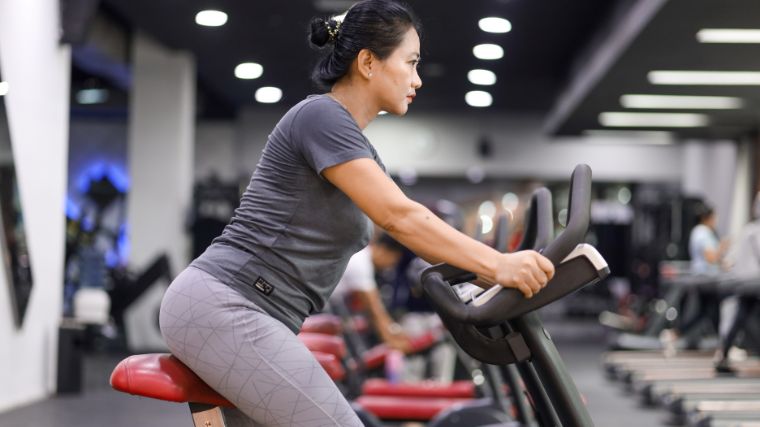 A person using an exercise bike for cardio exercise.