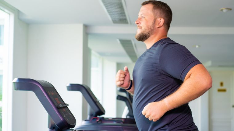 A person running on the treadmill to burn calories.