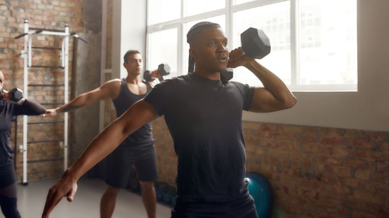 People training with a single dumbbell.