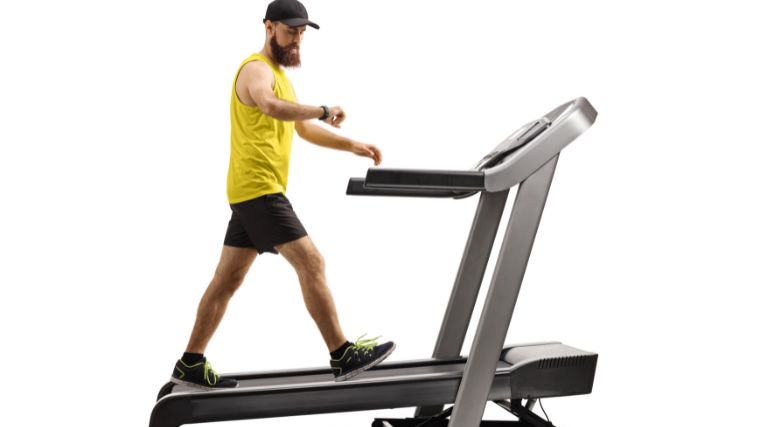 A gymgoer on a treadmill with a slight incline. 