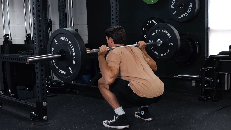 Our tester Squatting with the REP Fitness Colorado Bar.