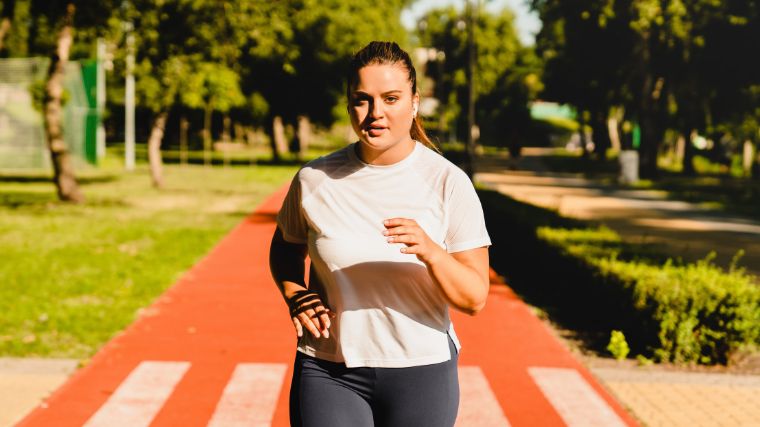 An athlete does a fartlek run on a track outside.