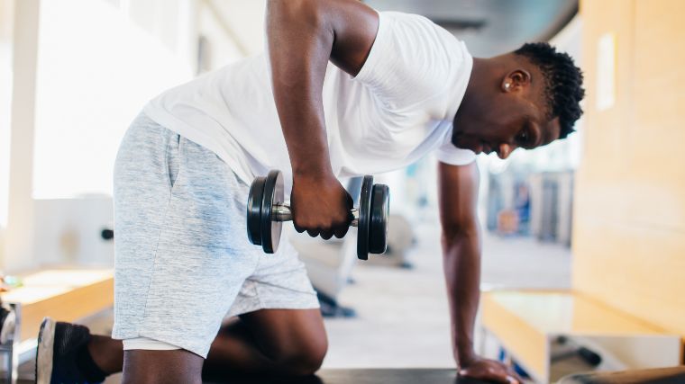 A person doing dumbbell rows.