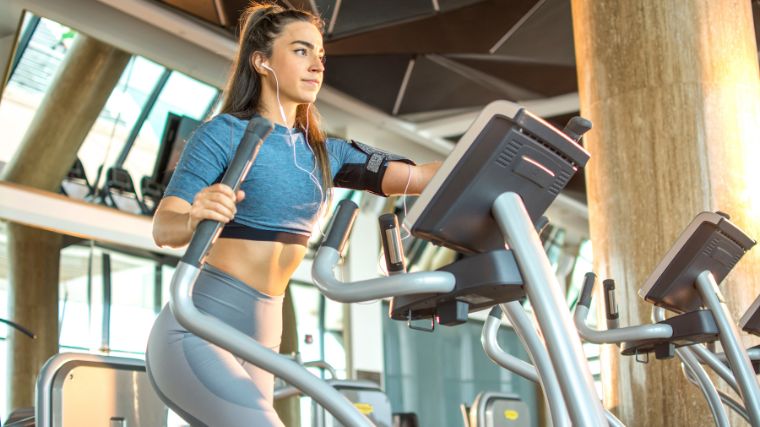 A person doing low-impact cardio with the elliptical machine.