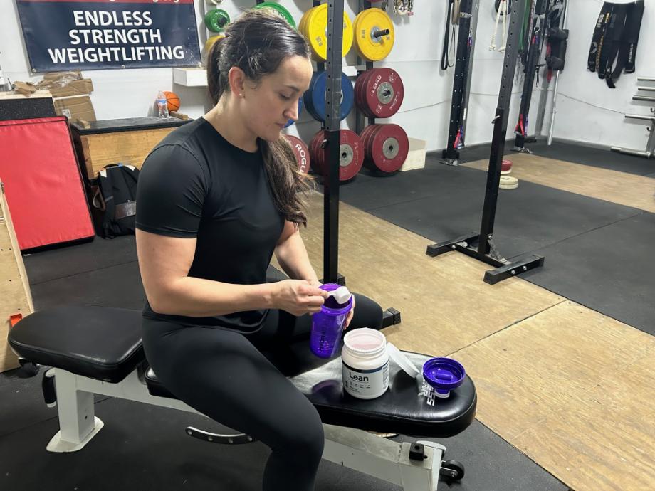BarBend's Kate Meier mixing Transparent Labs LEAN pre-workout.